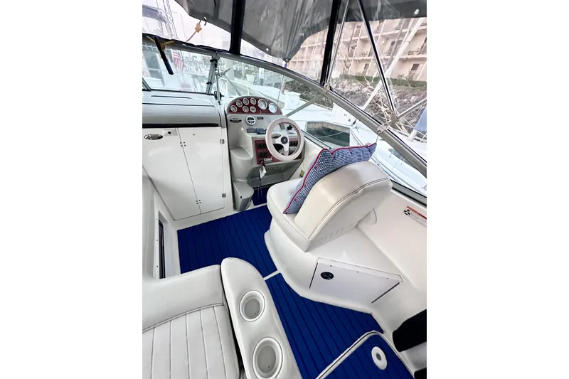 Slide: The Image of 2007 Bayliner 245 Ciera boat interior with blue flooring and white seating. - 2