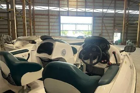 Slide: The Image of 2003 Yamaha LS2000 boat interior with steering wheel and seats in a warehouse. - 3