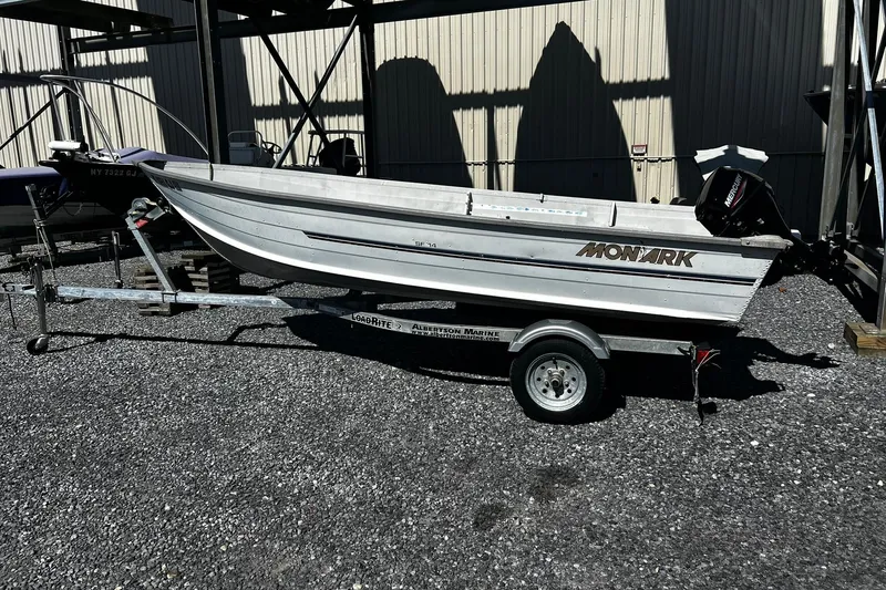 Slide: The Image of 1997 Monark SF 14 S boat on trailer, parked outdoors in gravel lot. - 1