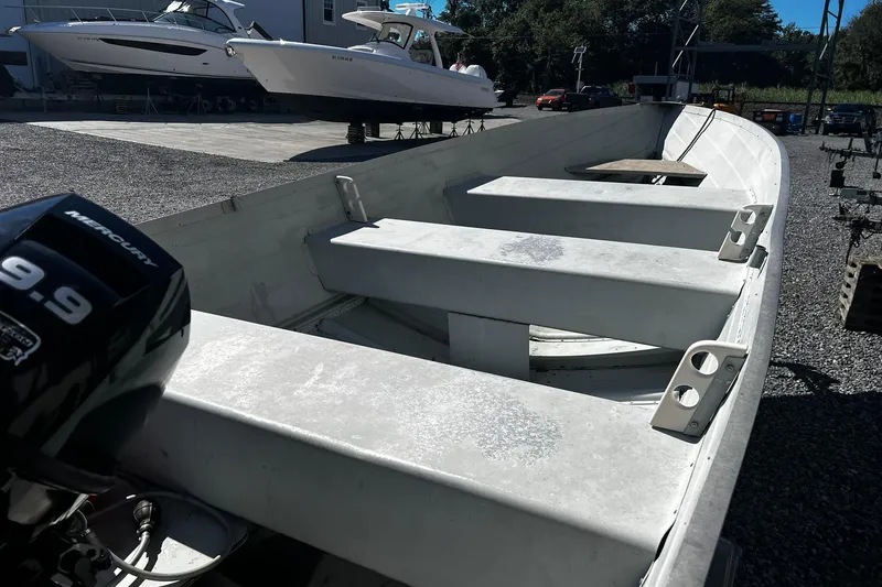 Slide: The Image of 1997 Monark SF 14 S boat with Mercury 9.9 motor, docked outdoors. - 5