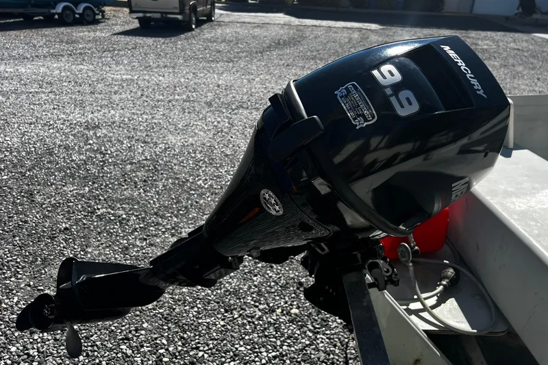 Slide: The Image of Outboard motor on a Monark SF 14 S boat, 1997 model, in a gravel lot. - 6