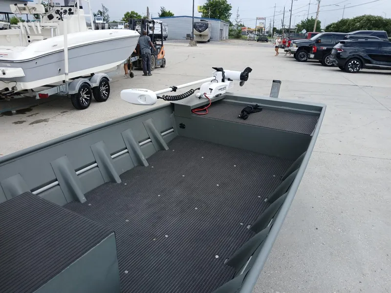 Slide: The Image of 2000 Southfork 16 CC boat with trolling motor in a parking lot. - 3