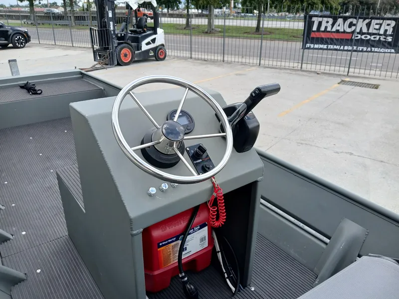 Slide: The Image of Steering console of a 2000 Southfork 16 CC boat with control panel and red safety cord. - 4