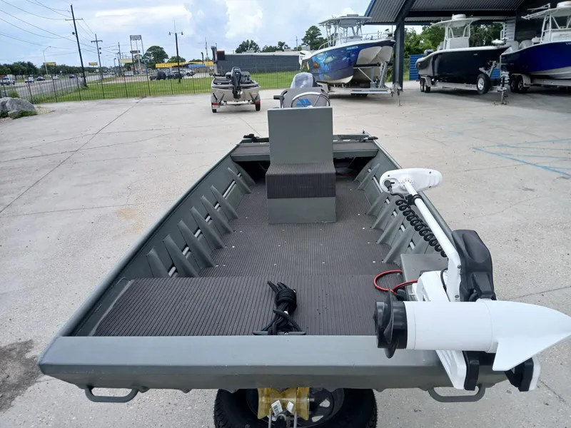 Slide: The Image of 2000 Southfork 16 CC boat with trolling motor in a marina setting. - 7