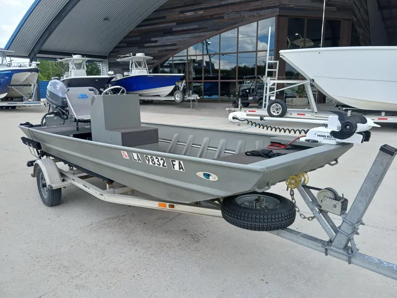 Slide: The Image of 2000 Southfork 16 CC boat on trailer, parked outside a showroom. - 8