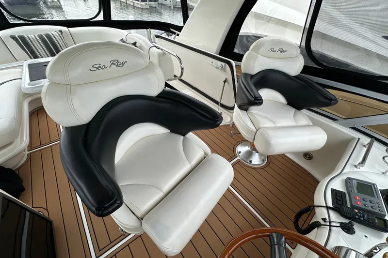Slide: The Image of Luxurious interior of 2004 Sea Ray 420 Sedan Bridge with plush seating and modern controls. - 12