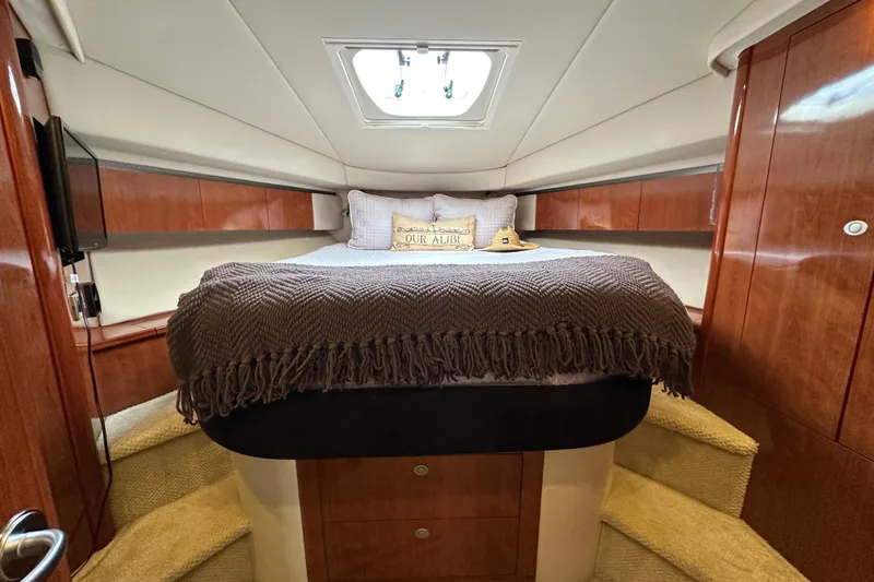 Slide: The Image of Luxurious cabin interior of 2004 Sea Ray 420 Sedan Bridge yacht with cozy bedding. - 20