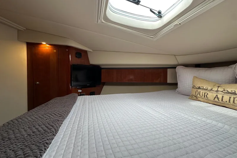 Slide: The Image of Luxurious cabin interior of 2004 Sea Ray 420 Sedan Bridge yacht with cozy bedding. - 21