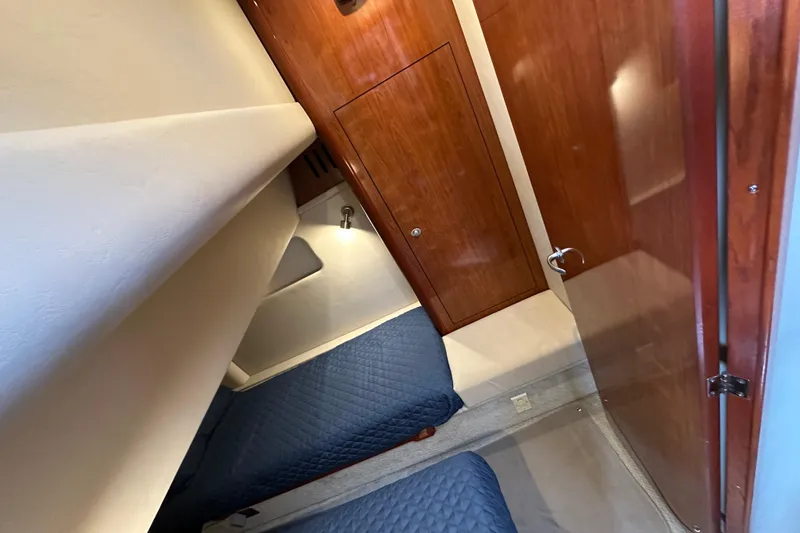 Slide: The Image of Interior cabin of 2004 Sea Ray 420 Sedan Bridge with twin beds and wooden cabinetry. - 28