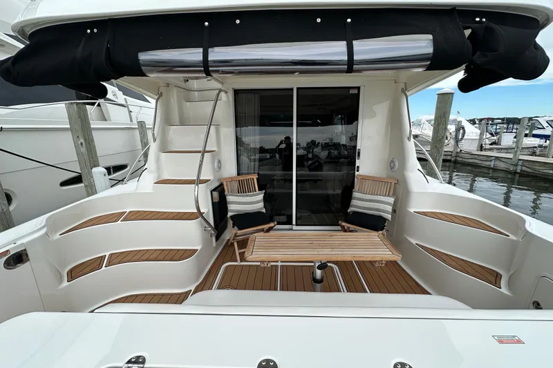Slide: The Image of 2004 Sea Ray 420 Sedan Bridge yacht with elegant deck seating and wooden accents. - 3
