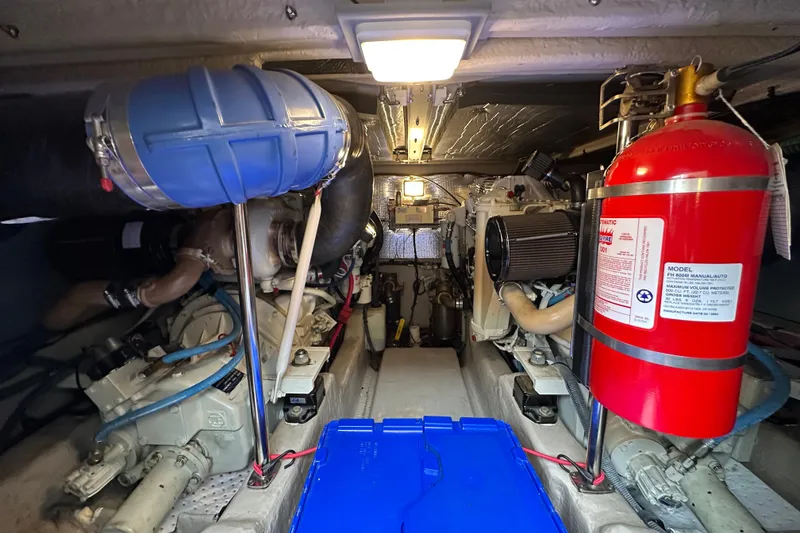 Slide: The Image of Engine room of 2004 Sea Ray 420 Sedan Bridge with fire extinguisher and mechanical components. - 32
