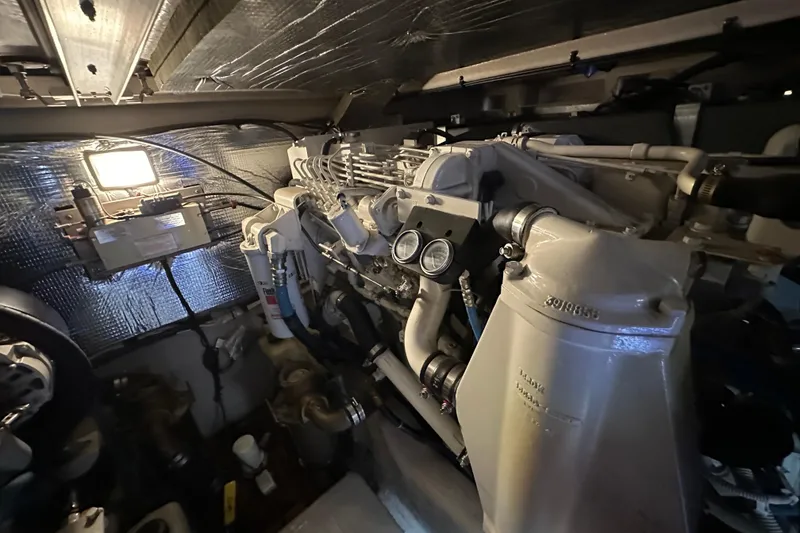 Slide: The Image of Engine room of 2004 Sea Ray 420 Sedan Bridge with visible machinery and components. - 33