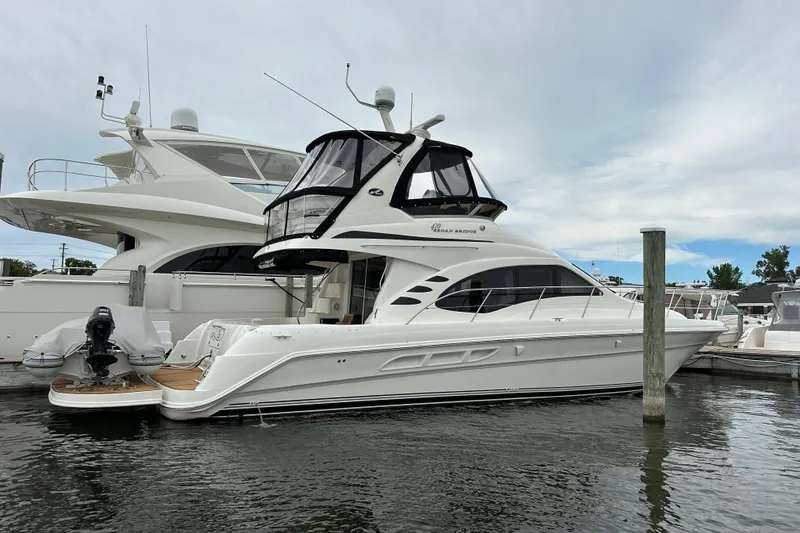 Slide: The Image of 2004 Sea Ray 420 Sedan Bridge yacht docked at marina, side view. - 36