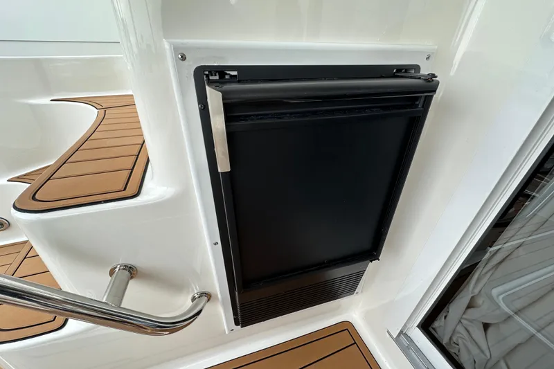 Slide: The Image of Built-in refrigerator on 2004 Sea Ray 420 Sedan Bridge yacht with teak flooring. - 5