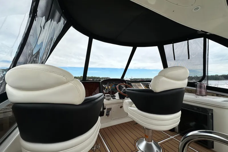 Slide: The Image of Interior view of 2004 Sea Ray 420 Sedan Bridge yacht cockpit with luxurious seating. - 8