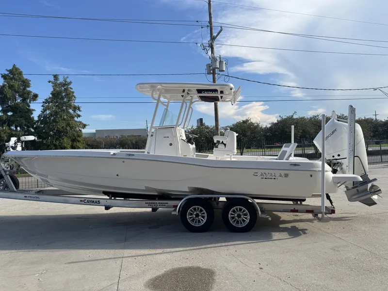 Slide: The Image of 2025 Caymas HB 28 boat on trailer, side view, clear sky background. - 10
