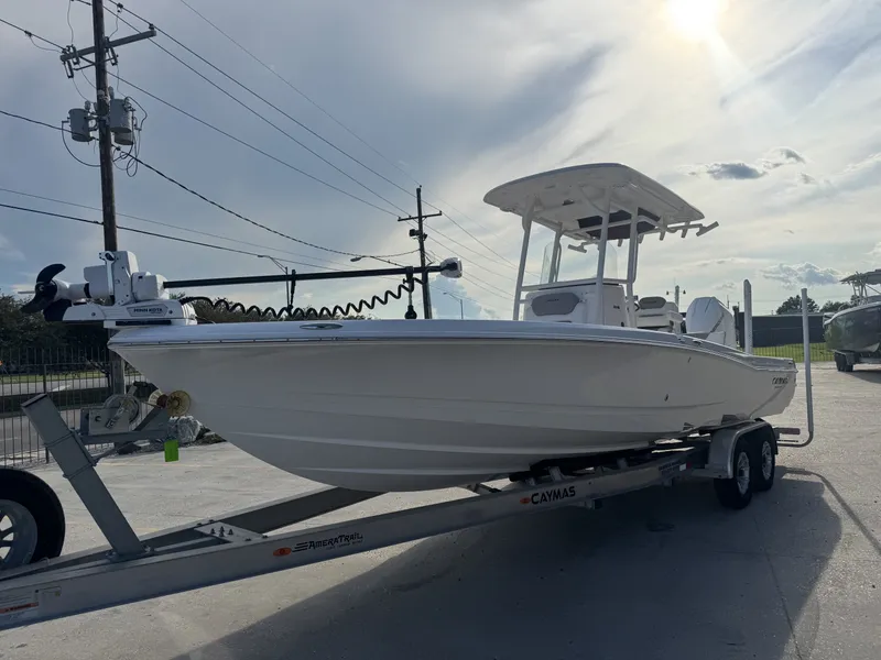 Slide: The Image of 2025 Caymas HB 28 boat on trailer under sunny sky. - 11