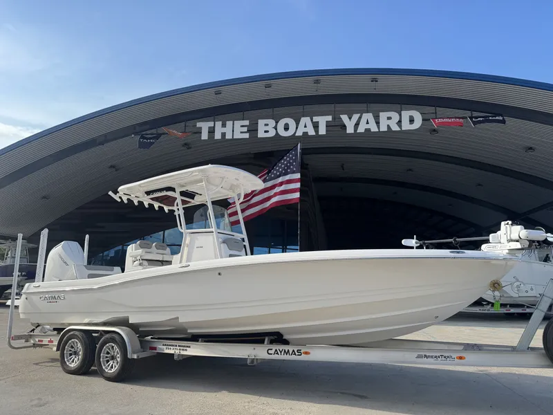 Slide: The Image of 2025 Caymas HB 28 boat on trailer at The Boat Yard, American flag displayed. - 3