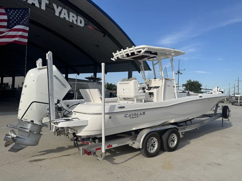 Slide: The Image of 2025 Caymas HB 28 boat on trailer at boat yard, featuring Mercury engine. - 4