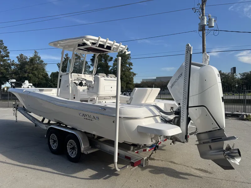 Slide: The Image of 2025 Caymas HB 28 boat on trailer, featuring a powerful Mercury outboard motor. - 5