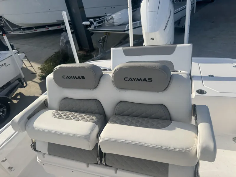 Slide: The Image of 2025 Caymas HB 28 boat seats with logo, featuring cushioned armrests and quilted design. - 6