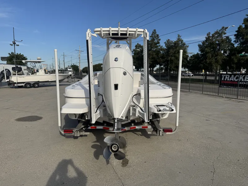 Slide: The Image of 2025 Caymas HB 28 boat rear view with outboard motor in a parking lot. - 9