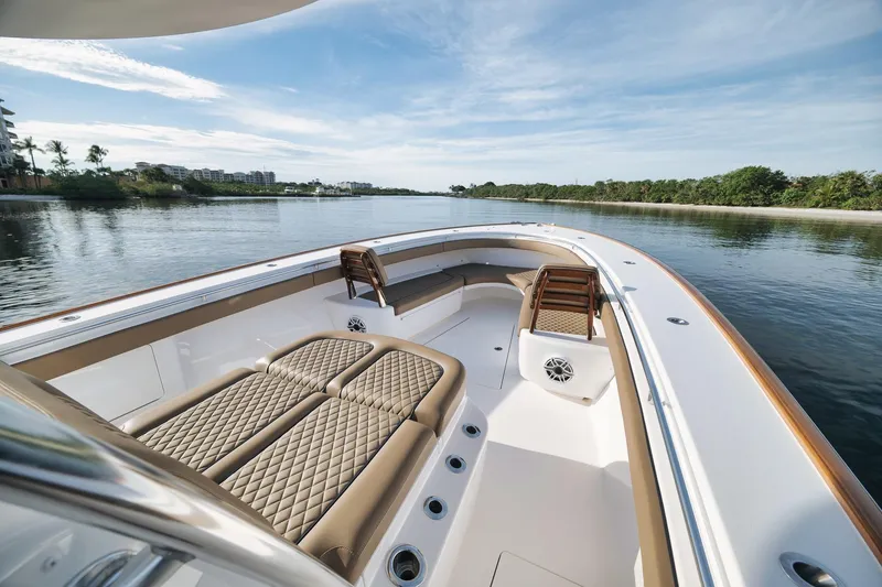 Slide: The Image of 2022 Valhalla Boatworks V-41 luxury boat interior on calm water, featuring elegant seating. - 12
