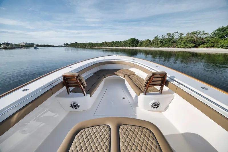 Slide: The Image of 2022 Valhalla Boatworks V-41 luxury boat interior with cushioned seating and scenic water view. - 14