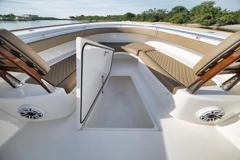 Slide: The Image of 2022 Valhalla Boatworks V-41 interior with open storage compartment and cushioned seating. - 17