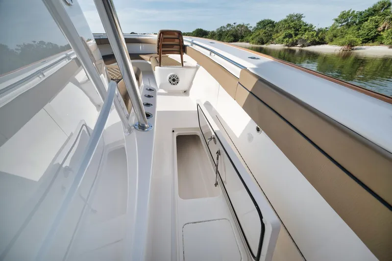 Slide: The Image of 2022 Valhalla Boatworks V-41 interior with storage compartment, sleek design, and scenic water view. - 19