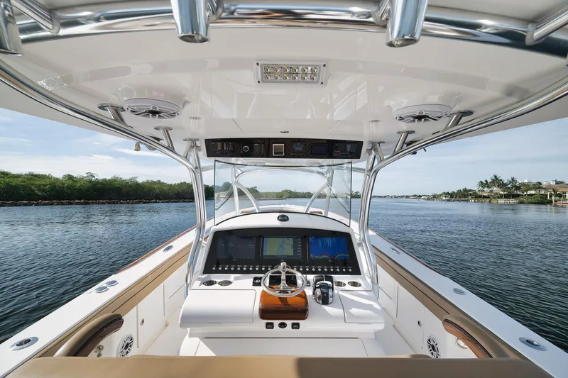Slide: The Image of 2022 Valhalla Boatworks V-41 helm with advanced navigation system on calm waters. - 30