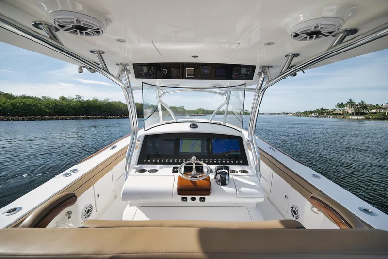 Slide: The Image of 2022 Valhalla Boatworks V-41 helm with advanced navigation system on calm waters. - 32