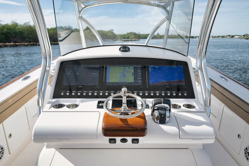 Slide: The Image of 2022 Valhalla Boatworks V-41 helm with advanced navigation displays on open water. - 33