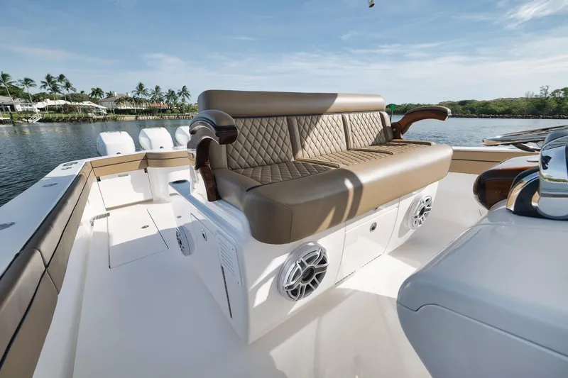 Slide: The Image of 2022 Valhalla Boatworks V-41 luxury seating with speakers, on a sunny waterfront. - 45