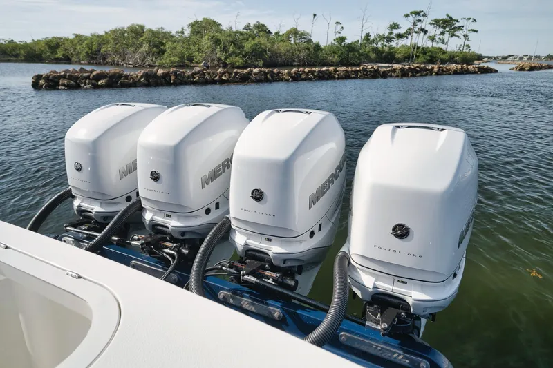 Slide: The Image of Four Mercury outboard engines on a 2022 Valhalla Boatworks V-41 in a scenic waterway. - 50