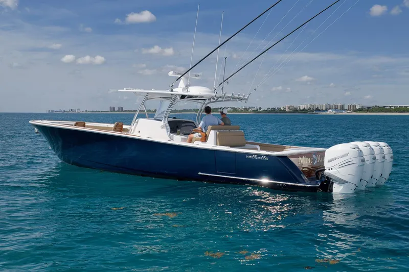 Slide: The Image of 2022 Valhalla Boatworks V-41 cruising on clear blue water, featuring powerful outboard engines. - 81