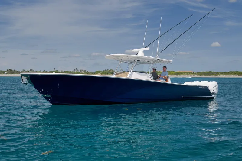 Slide: The Image of 2022 Valhalla Boatworks V-41 in blue, cruising on clear ocean waters. - 83