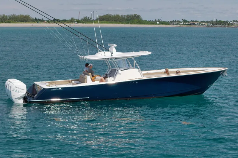 Slide: The Image of 2022 Valhalla Boatworks V-41 in blue, cruising on clear ocean waters. - 90