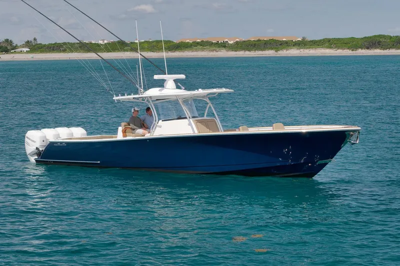 Slide: The Image of 2022 Valhalla Boatworks V-41 in blue, cruising on clear ocean waters. - 91