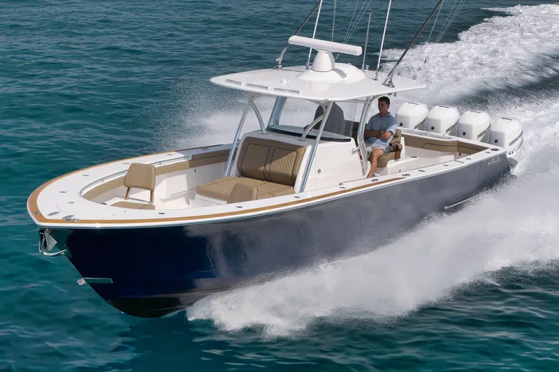 Slide: The Image of 2022 Valhalla Boatworks V-41 cruising on clear blue water, showcasing sleek design and powerful engines. - 93