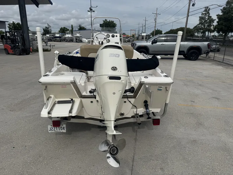 Slide: The Image of 2018 Key West 1720 Sportsman boat with outboard motor in a parking lot. - 10