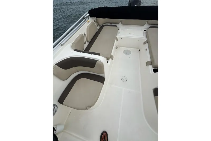 Slide: The Image of 2017 Bayliner Element F21 boat interior with cushioned seating and open deck space. - 11