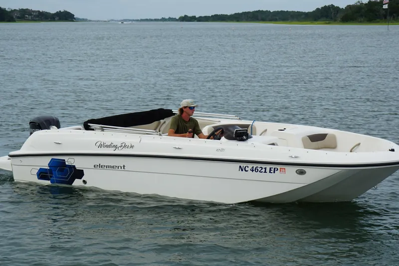 Slide: The Image of 2017 Bayliner Element F21 boat cruising on a calm lake. - 14