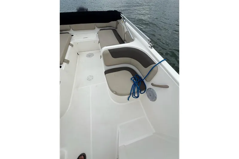 Slide: The Image of 2017 Bayliner Element F21 boat interior with seating and blue rope on deck. - 7