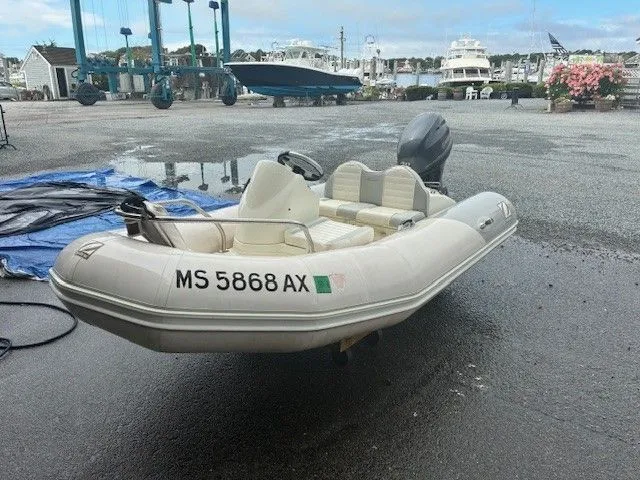 Slide: The Image of 2011 Zodiac YACHT LINE 340DL inflatable boat on wet dock, marina background. - 0