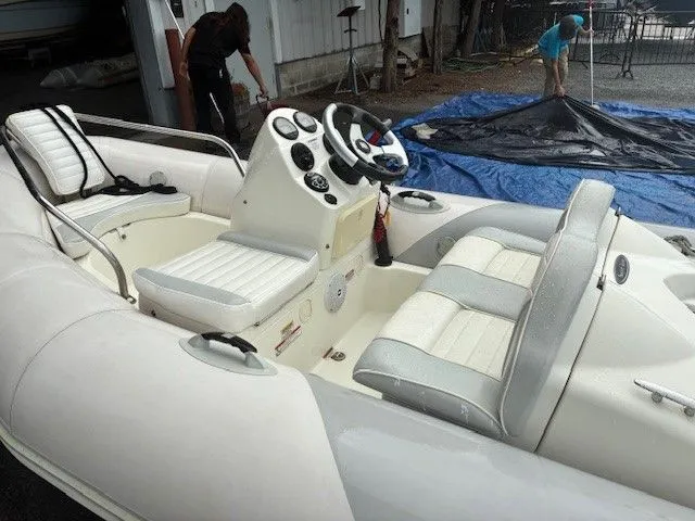 Slide: The Image of 2011 Zodiac YACHT LINE 340DL inflatable boat with white seating and control console. - 1