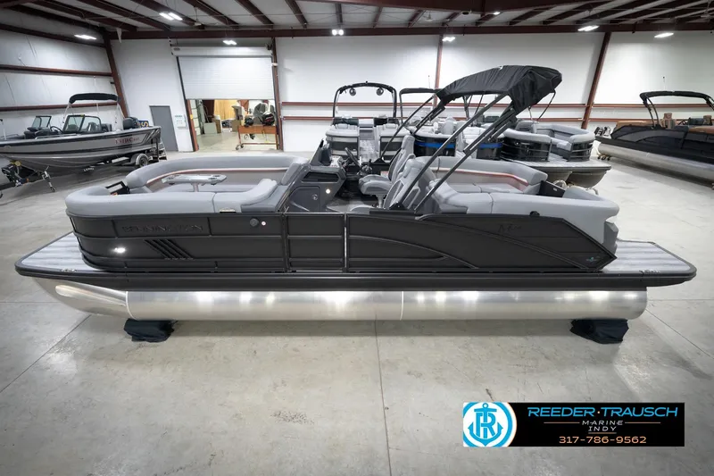 The Image of 2026 Bennington 24 MFB pontoon boat in showroom, featuring sleek design and modern amenities. - 0