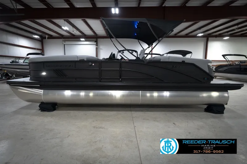 Slide: The Image of 2026 Bennington 24 MFB pontoon boat in showroom, featuring sleek design and modern amenities. - 10