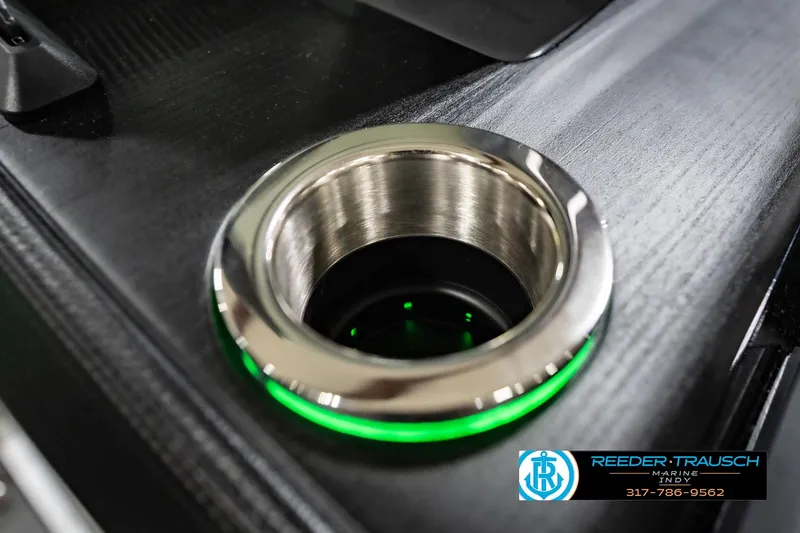 Slide: The Image of Illuminated cup holder on 2026 Bennington 24 MFB boat, featuring sleek design and green LED lighting. - 101