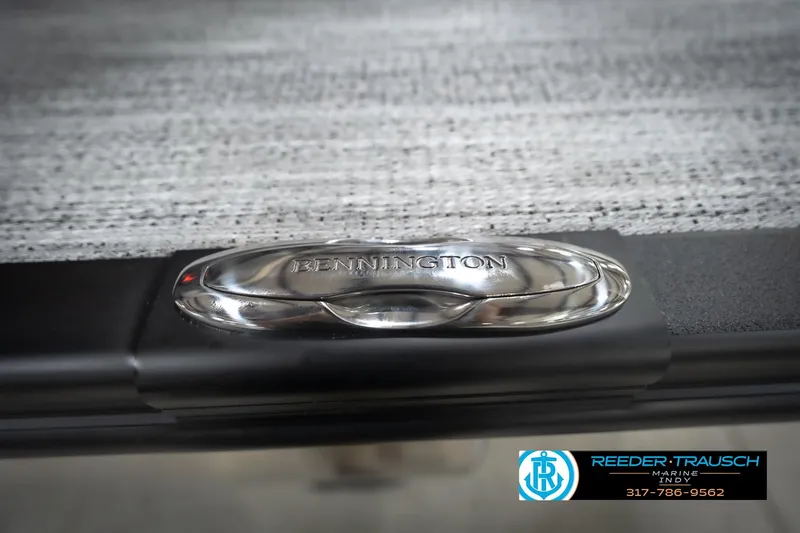 Slide: The Image of Close-up of 2026 Bennington 24 MFB boat detail with logo and textured surface. - 106